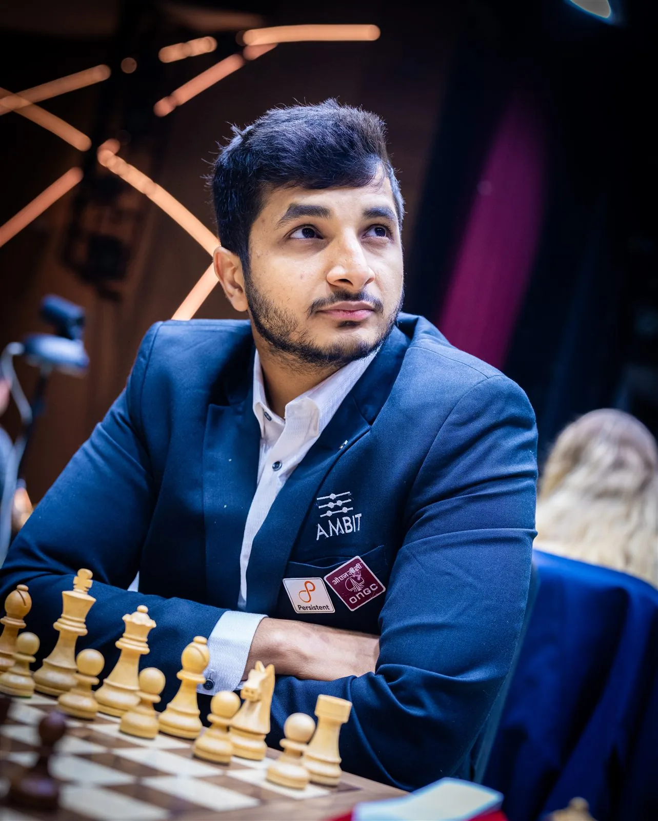 Vidit Gujrathi at the board with sponsor logos